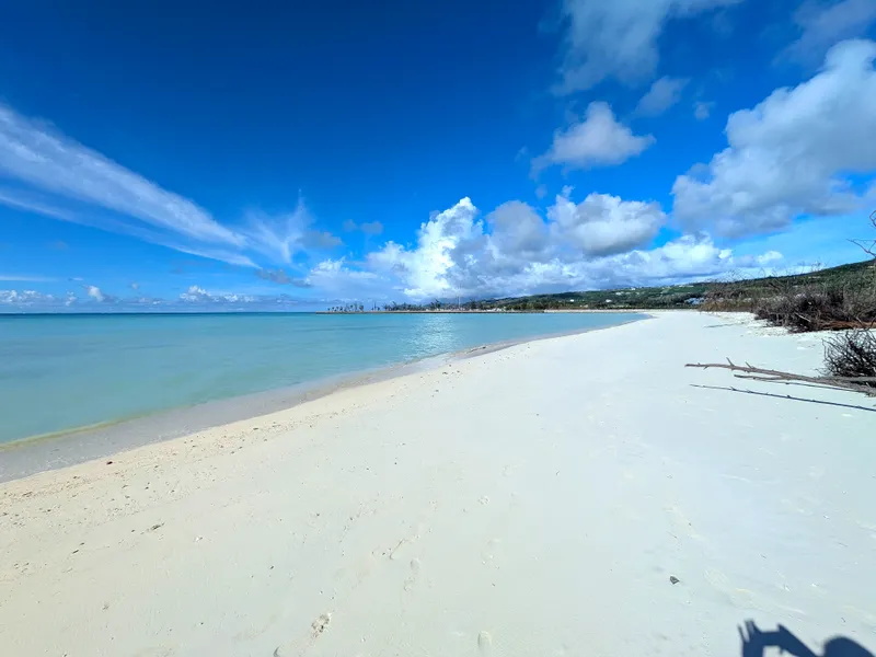 Micro Beach, Garapan, looking north along the white sand shoreline toward Smiling Cove Marina