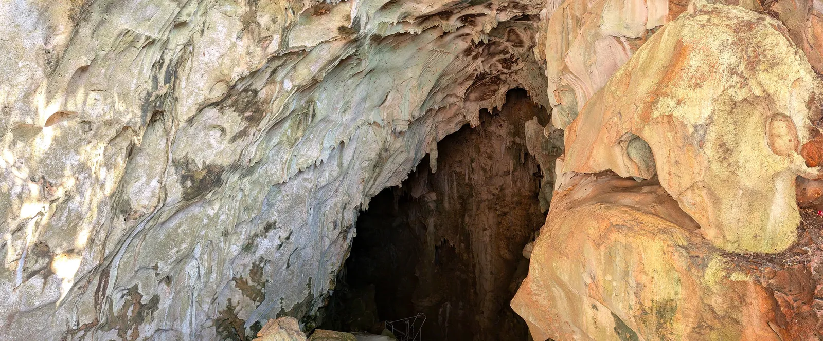 Panorama across the entrance chamber of Kalabera Cave, showing the full span of the limestone opening