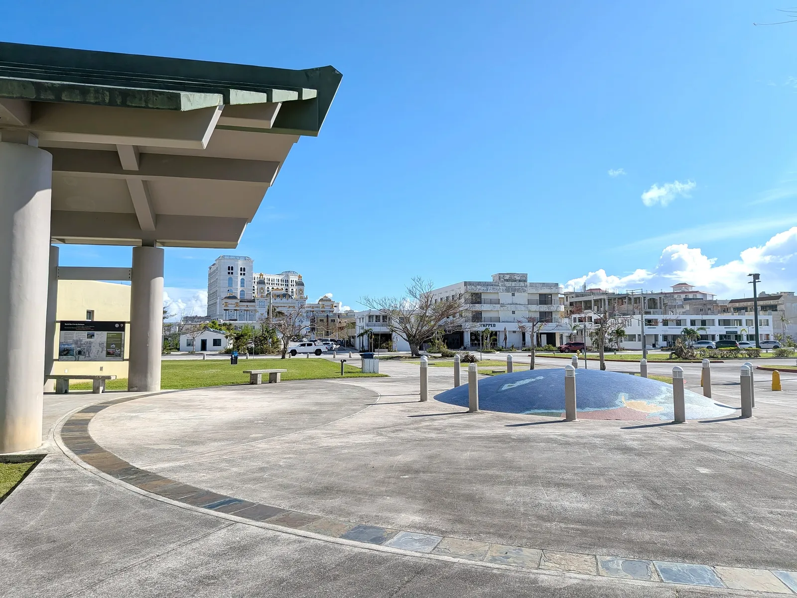 The mosaic map plaza at American Memorial Park's visitor center, with the Garapan skyline visible beyond