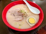 Tonkotsu pork bone ramen with sliced chashu, bean sprouts, and a soft-boiled egg at Himawari Restaurant, Garapan