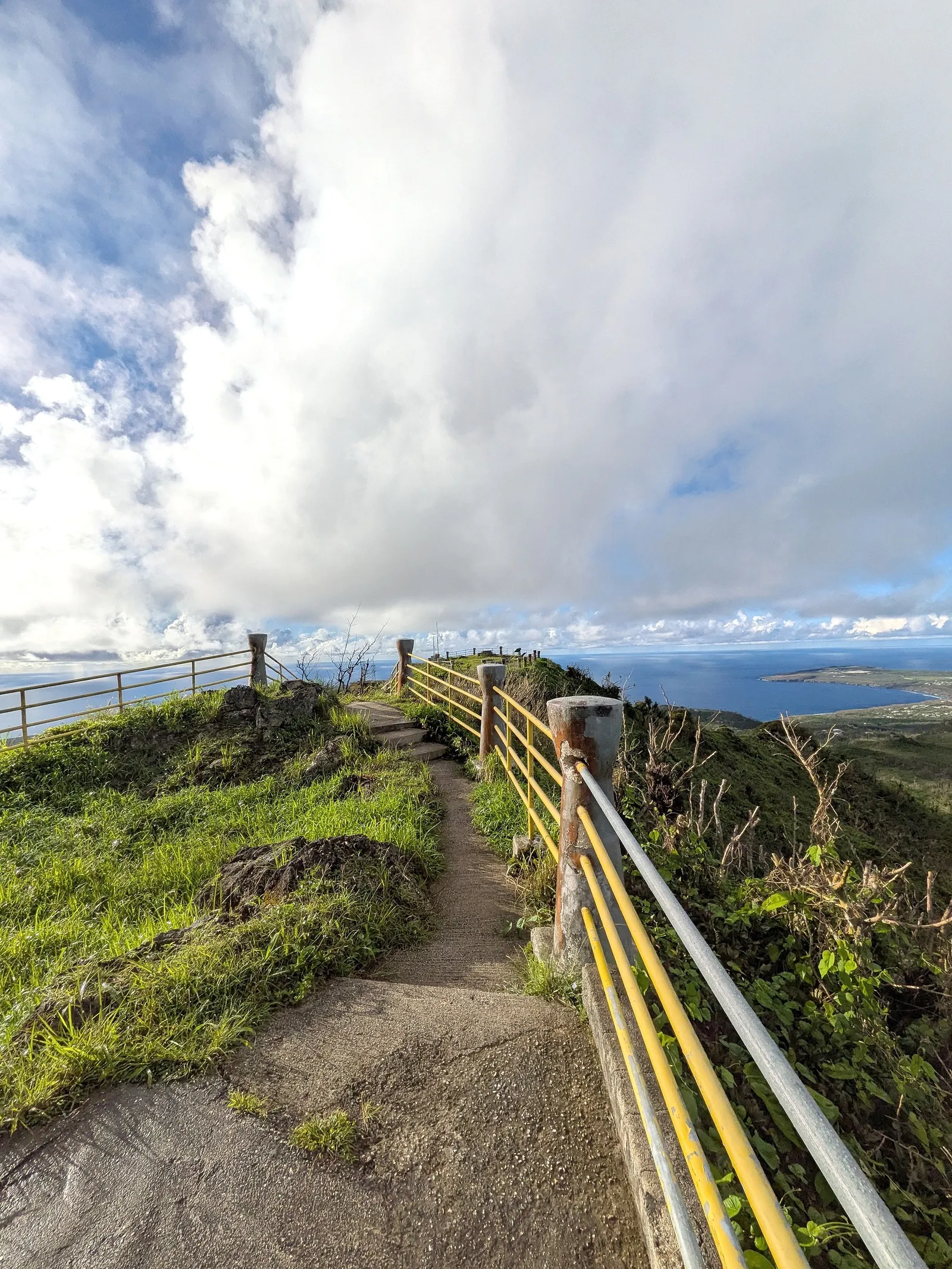 The narrow railed path along Mount Tapochau's summit ridge, with ocean visible on both sides