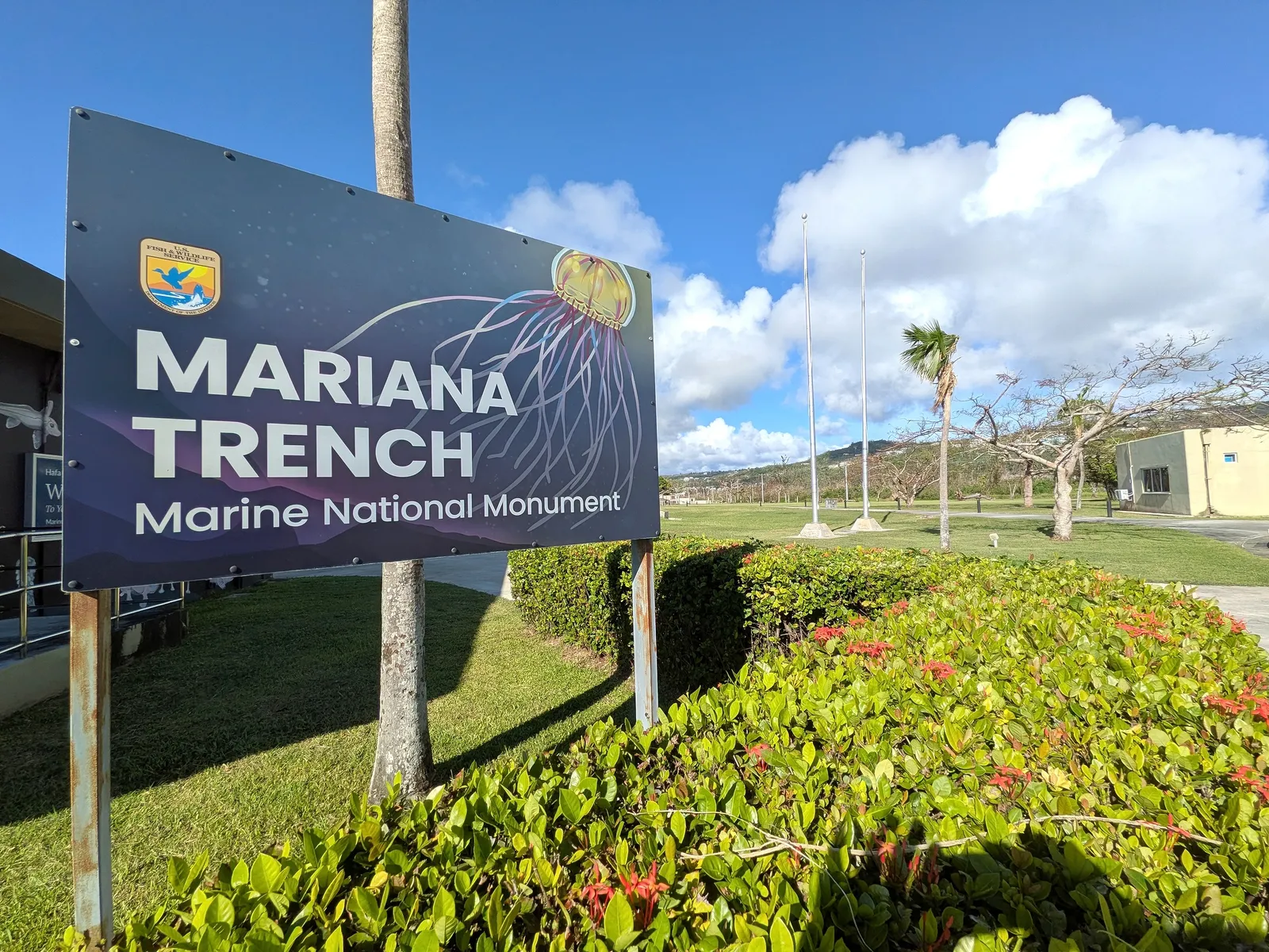 The American Memorial Park Visitor Center entrance, with its distinctive angled roof and a mosaic map of the Mariana Islands in the plaza
